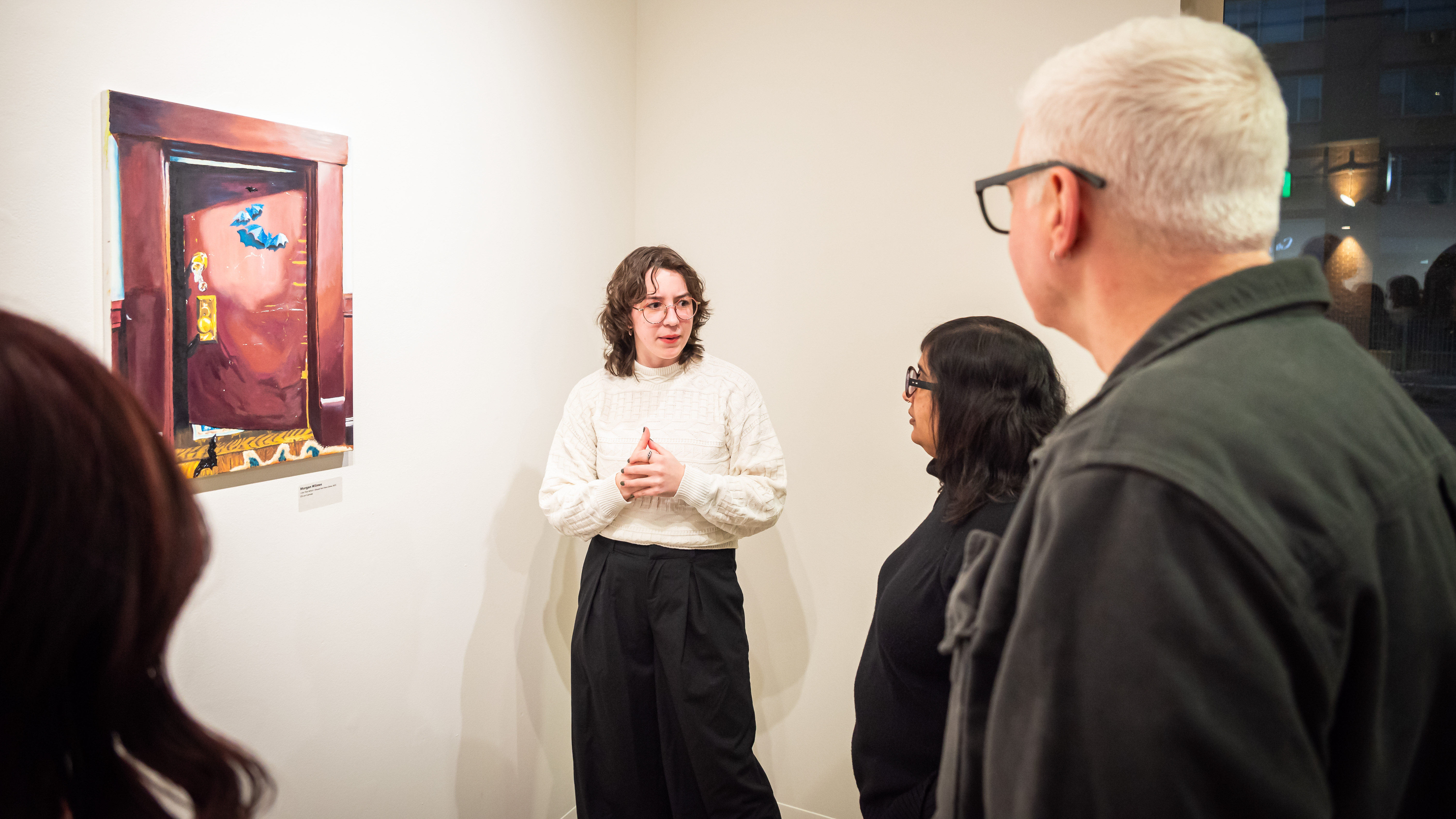 Loyola Fine Arts Faculty attending a student artist talk in Ralph Arnold Gallery