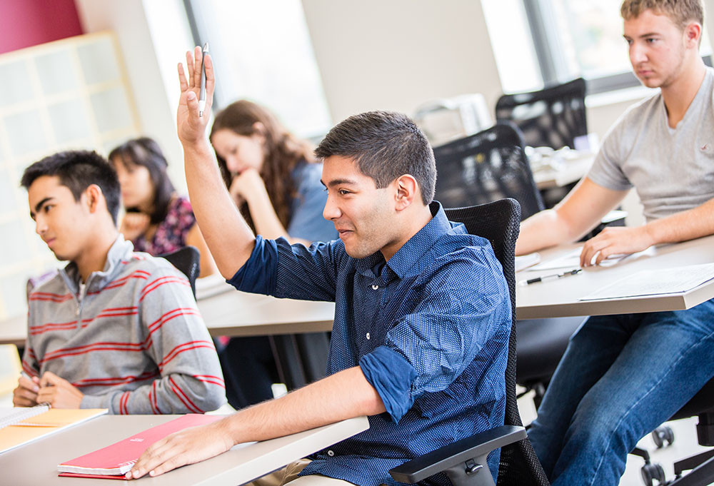 Student raising his hand in class