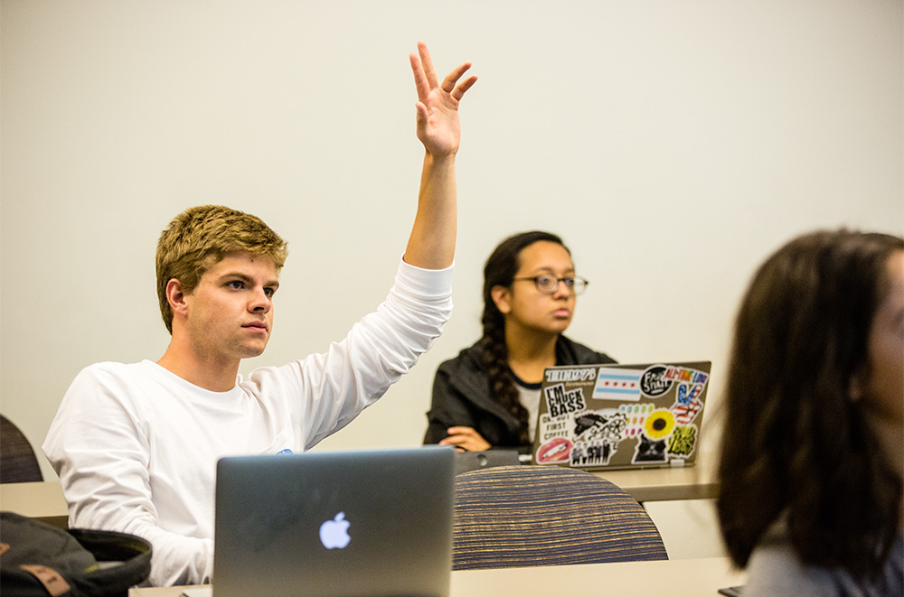 Student raising his hand in class