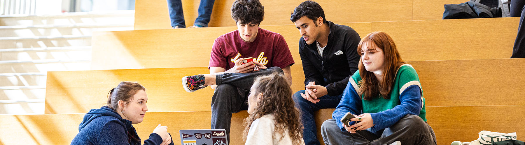 A group of Loyola students converse inside of the Schreiber Center