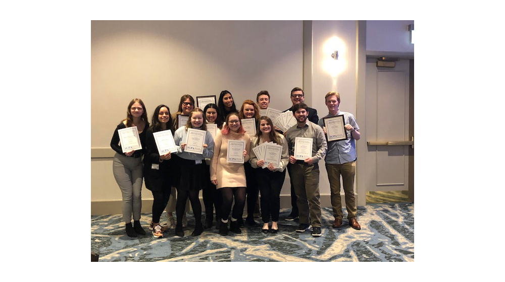 The Phoenix staff display the 18 awards received at the Illinois College Press Association convention in Chicago