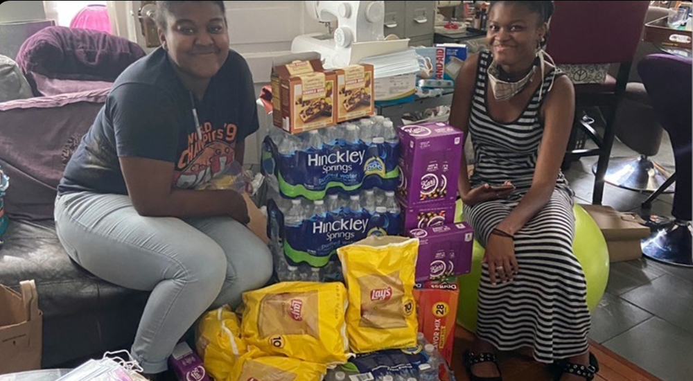 Indonesia Dixon and her sister, Farj Jaco, with some of the supplies they purchased through funds raised by their organization. 