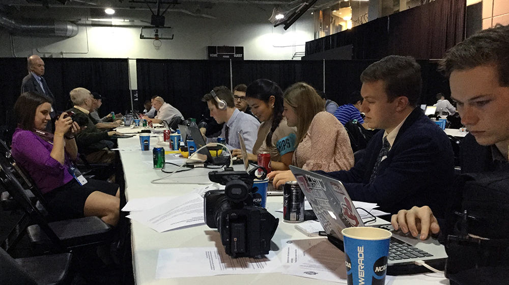 Loyola University School of Communication students work in the media room of the Philips Arena in Atlanta during the Elite 8 games. (From left) Kelsey Frew, Nick Schulz, Conor Bergin, Hanako Maki, Hayley Spitler, Chris Hacker and Henry Redman.