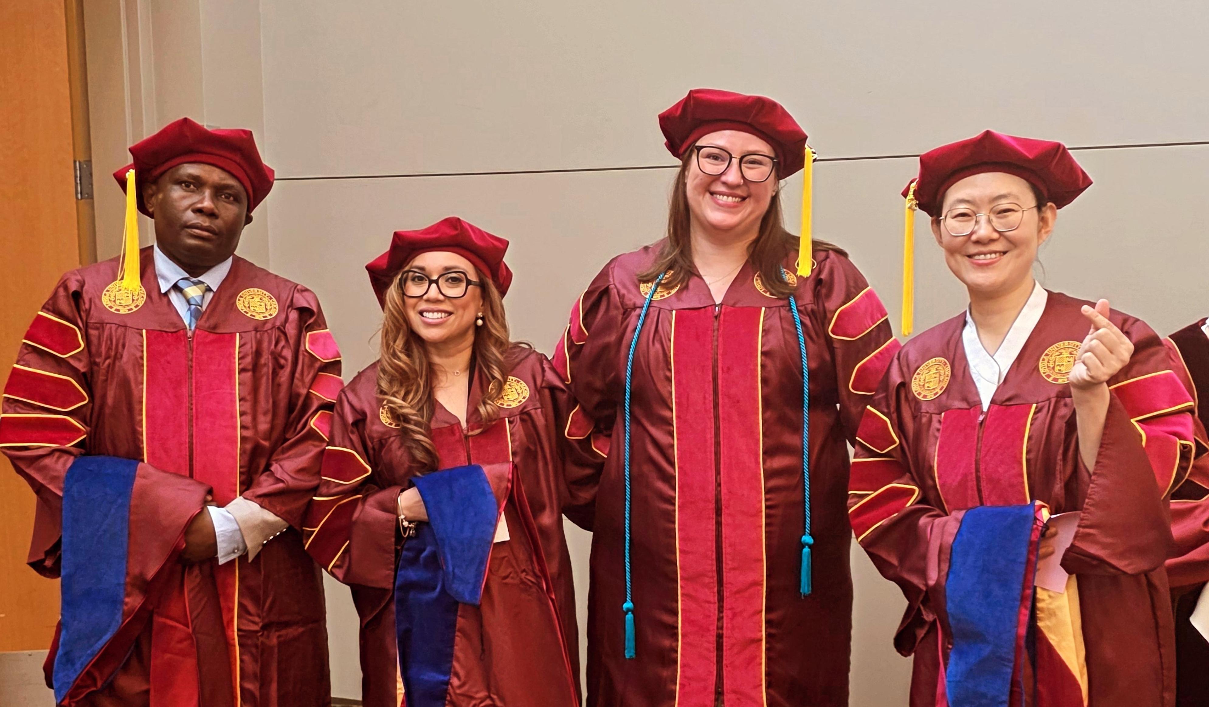 Dr. David Apopo, Dr. Marjorie Colindres, Dr. Brianna Sorensen, and Dr. Sungsim Lee posing at their graduation ceremony