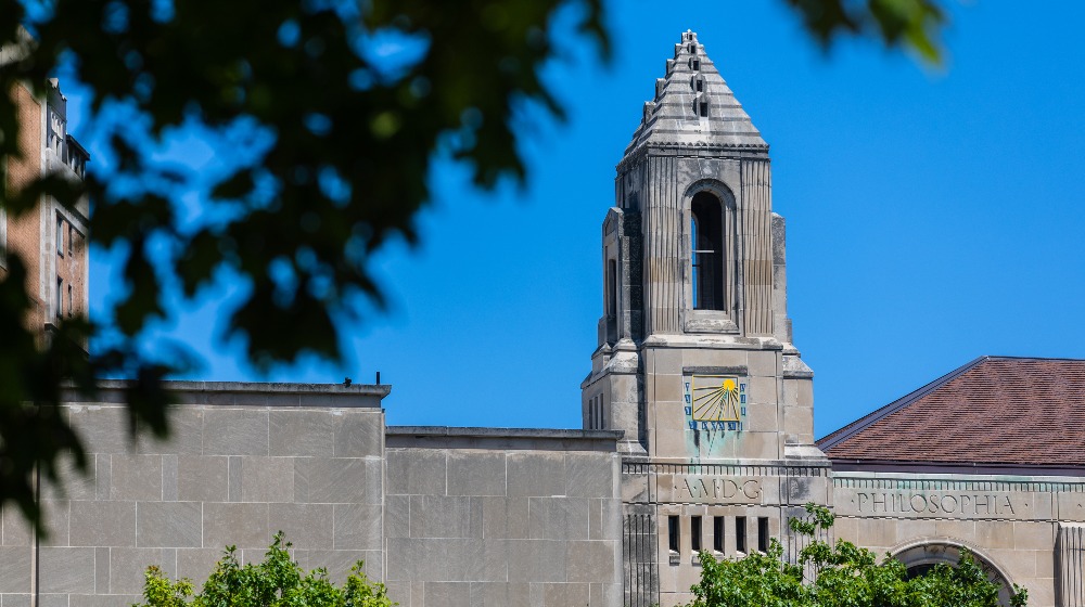 The Cudahy Library clocktower against a blue sky.