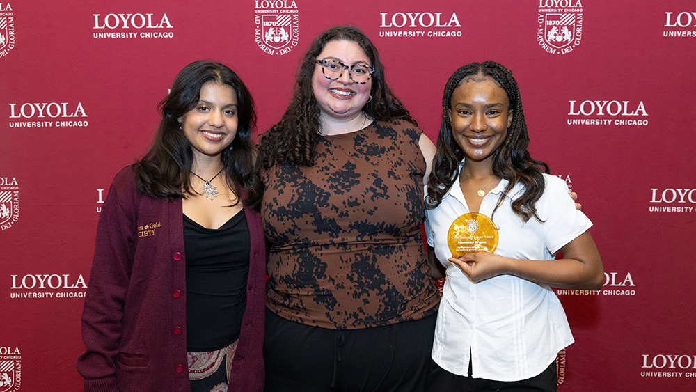 Jamie Capetillo poses for a photo with two students who were recognized at the 2026 Excellence Awards.