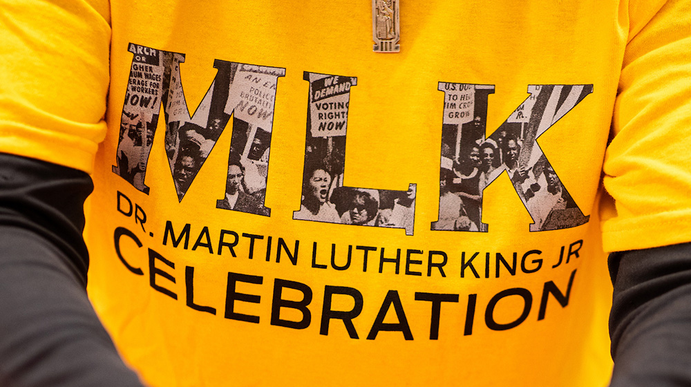 A close-up of a volunteer's shirt that says 