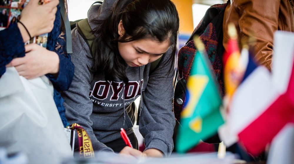 image of female student winning up for a program alongside other students