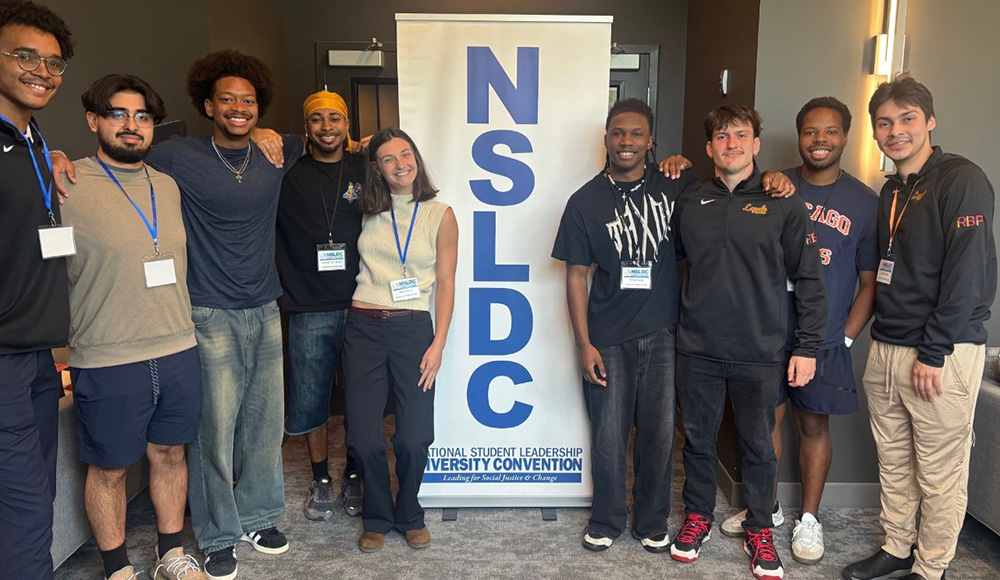 Rambler Brotherhood Project students pose for a group photo in front of a banner at the National Student Leadership Diversity Convention