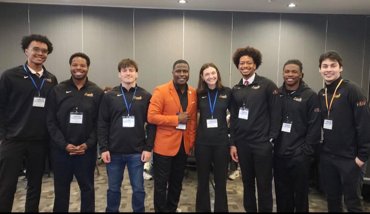 Rambler Brotherhood Project pose for a group photo with a panelist at the National Student Leadership Diversity Convention.