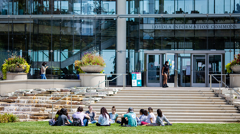 Students gather in front of the Loyola Information Commons
