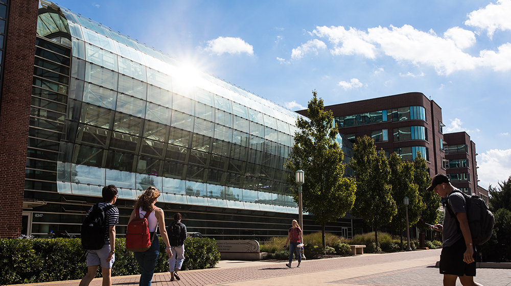 Exterior of the SES building with students walking by