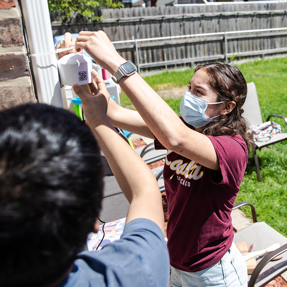 students installing an air quality monitor