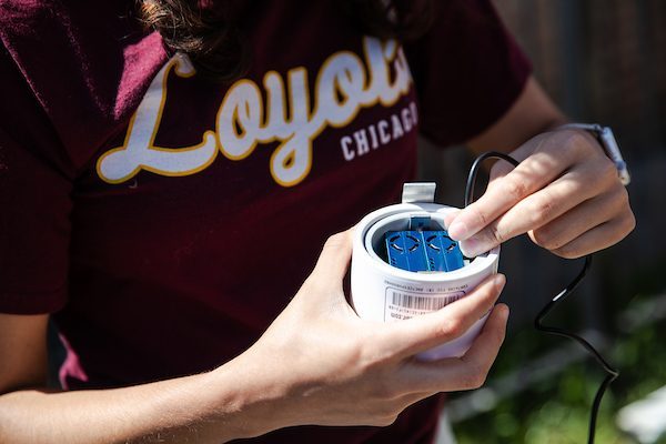 Student with air quality monitor in hand