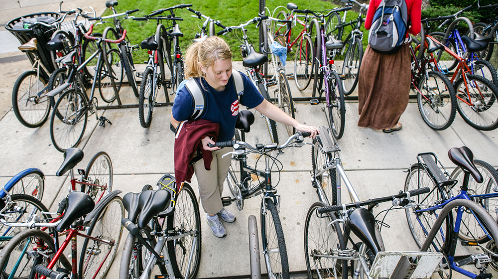 Student parking bike on campus