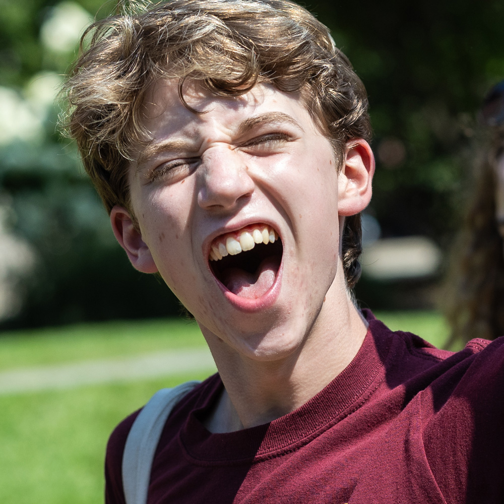 A student yells at an outdoor event during Welcome Week