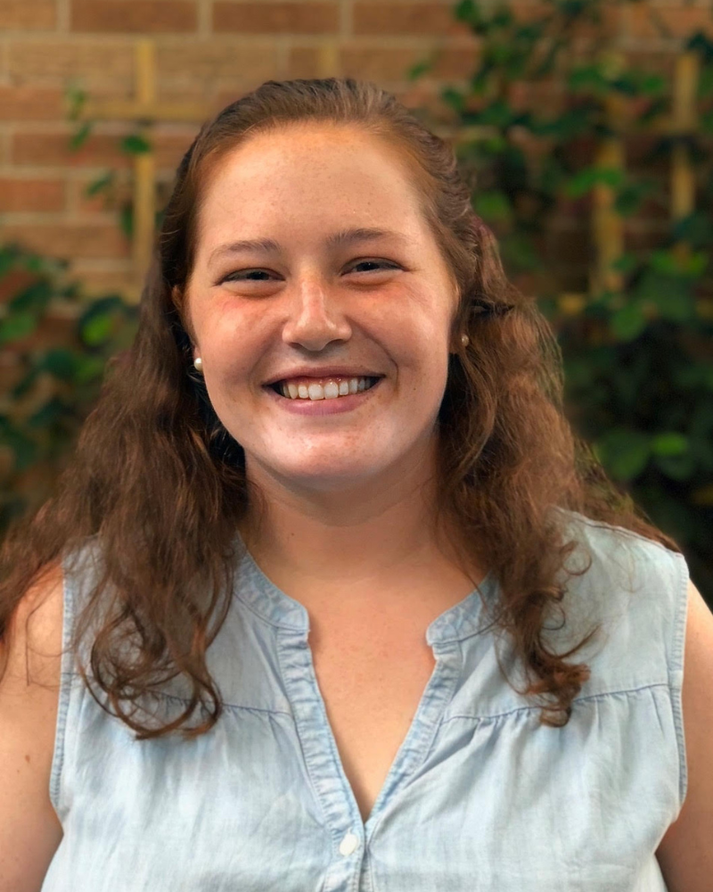 A woman with curly hair and a blue shirt