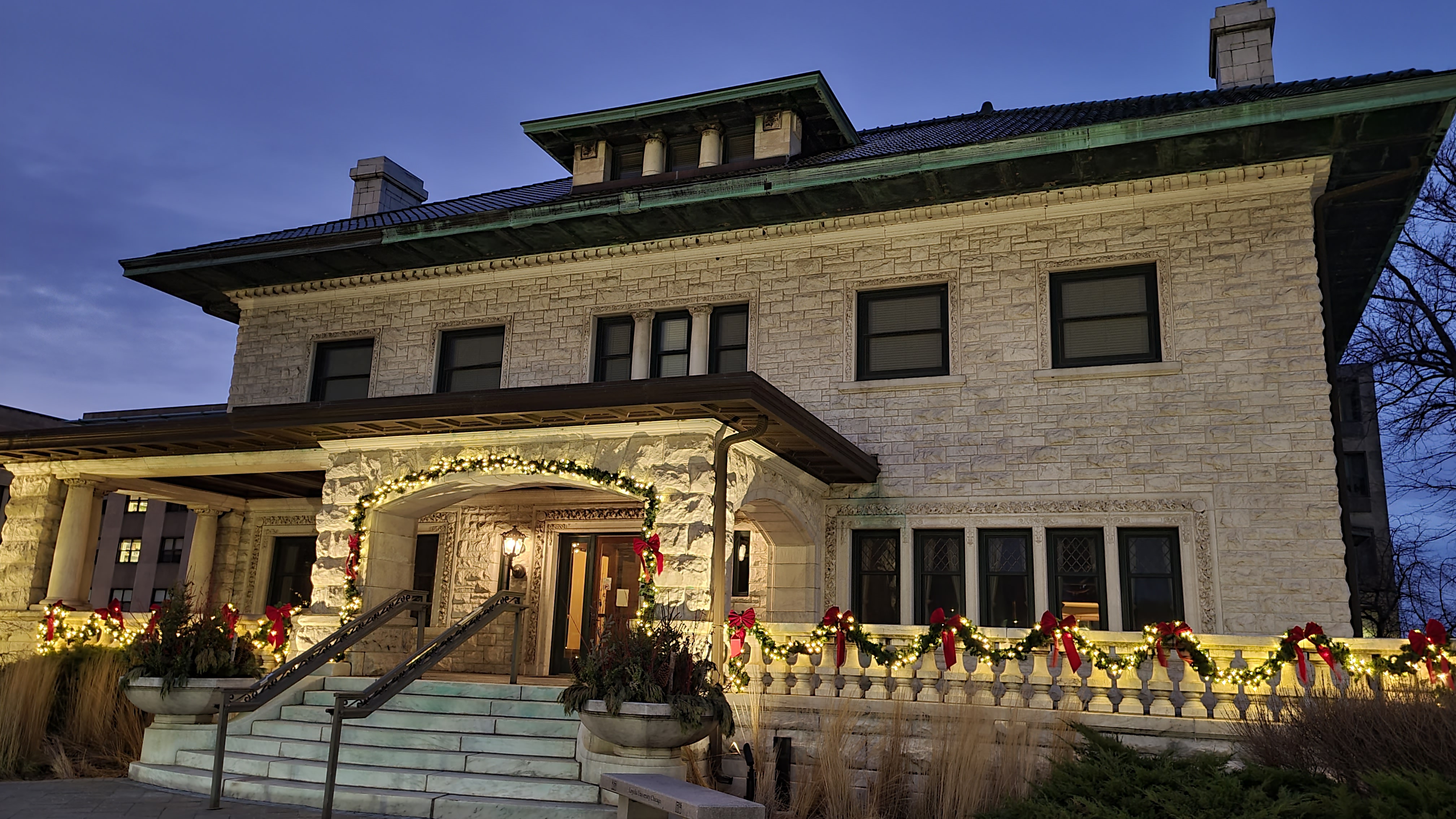 South entrance of Piper Hall decorated with holiday lights and bows