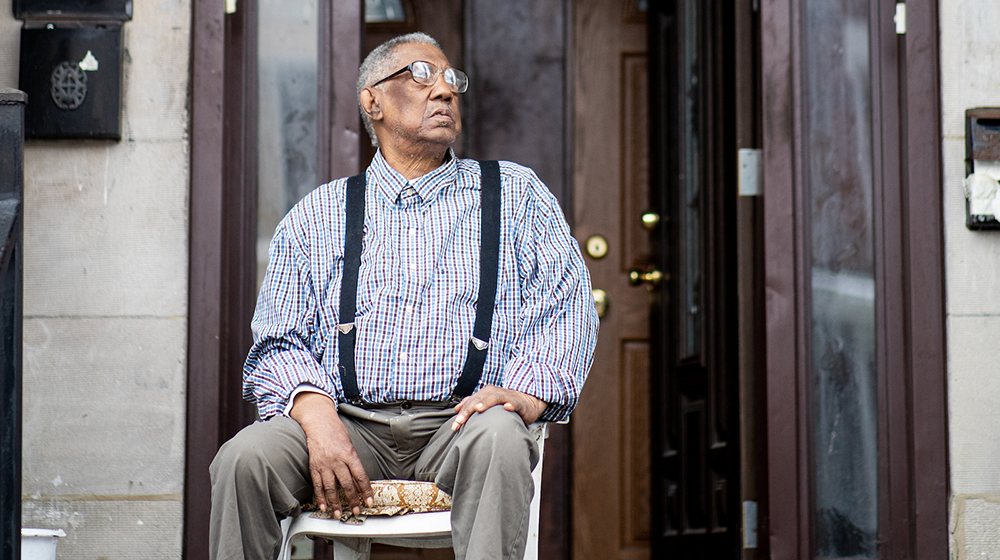 Clyde Ross was a major figure in the the Contract Buyers League, the community organization he helped launch with Jack Macknamara. Here, he sits outside his home in North Lawndale, where he has lived since 1958. (Photo: Lukas Keapproth)