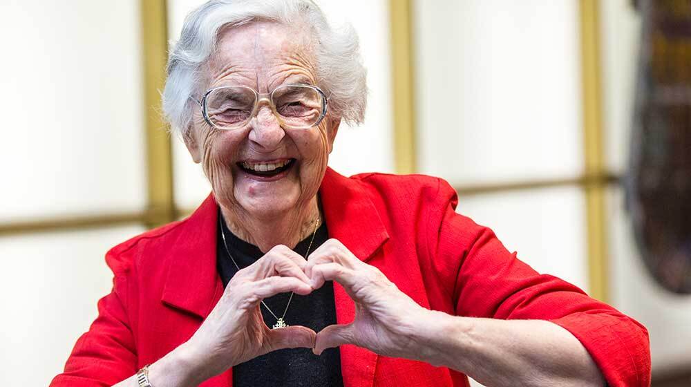 Sister Jean making a heart with her hands