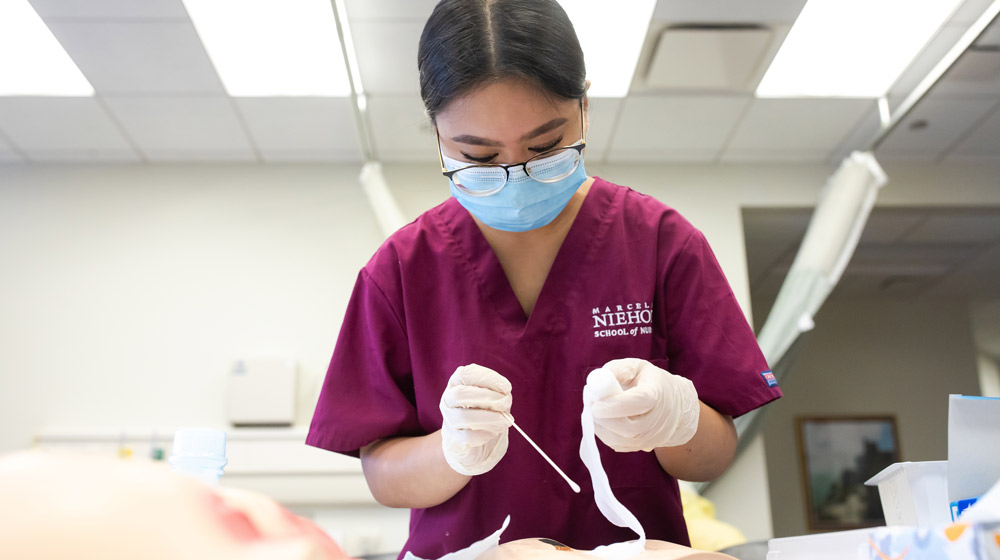 Getting ready to work with patients requires Loyola University Chicago nursing students to practice hands-on skills in Loyola's clinical simulation lab. (Photo: Lukas Keapproth)