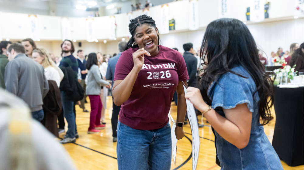 Lauryn Bausley wearing a maroon Match Day t-shirt celebrates with a classmate wearing a denim dress at the Match Day celebration Lauryn Bausley wearing a maroon Match Day t-shirt celebrates with a classmate wearing a denim dress at the Match Day celebration