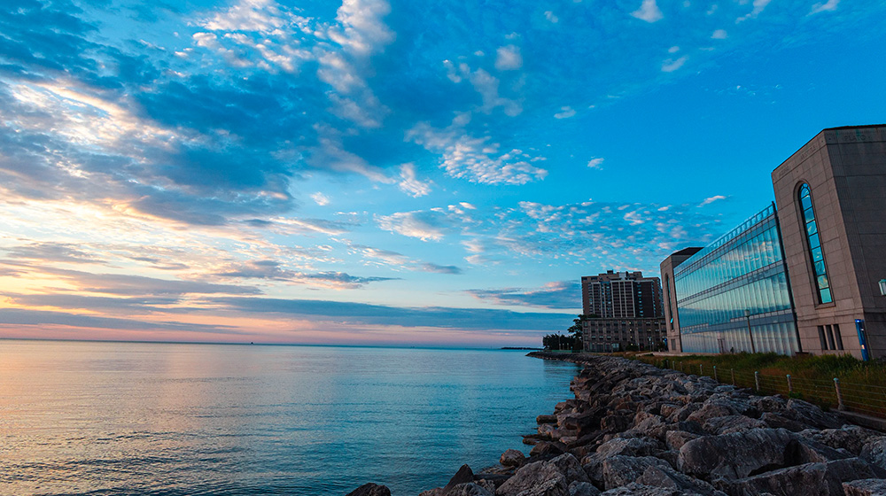 A view of the Information Commons shore and Lake Michigan during sunset
