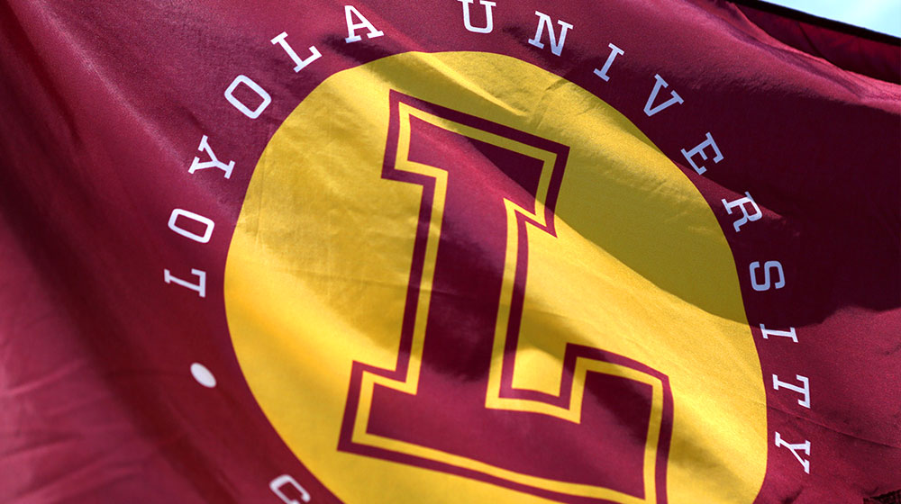 A closeup shot of the Loyola flag waving